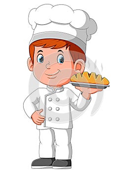 Young smiling man chef holding plate with bread