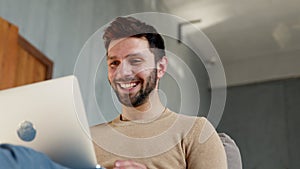 Young smiling man communicating by videoconference photo
