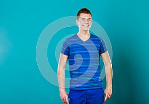 Young smiling man portrait on blue