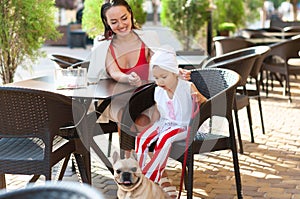 A young smiling mother spends time with her daughter