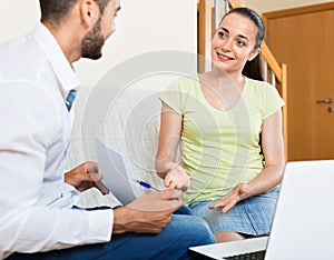 Young smiling pair with financial papers