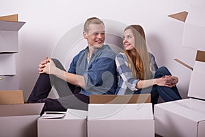 Young smiling pair sitting