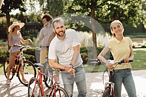 Young smiling peope with bicycles outdoors. photo