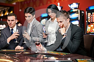 Young smiling people enjoying in a gambling