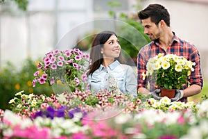 Young smiling people florists working in the garden photo