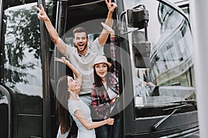 Young Smiling People Traveling on Tourist Bus