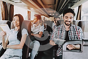 Young Smiling People Traveling on Tourist Bus