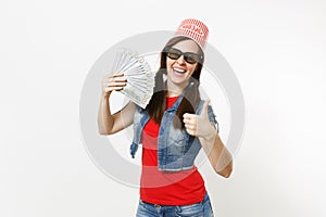 Young smiling pretty woman in 3d glasses with bucket for popcorn on head watching movie film, holding bundle of dollars