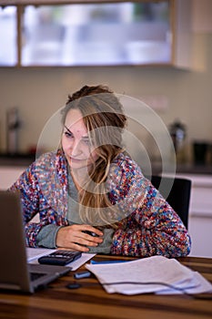 Young smiling pretty woman student using laptop