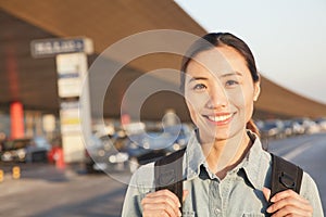 Young Smiling traveler portrait outside of airport