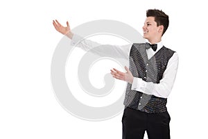 Young smiling waiter or butler gesturing welcome - isolated on w