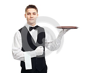 Young smiling waiter with empty tray