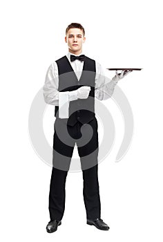 Young smiling waiter with empty tray