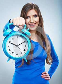 Young smiling woman in blue hold watch. Beautiful smiling girl