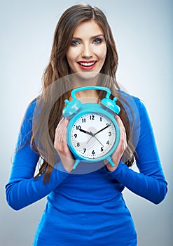 Young smiling woman in blue hold watch. Beautiful smiling girl