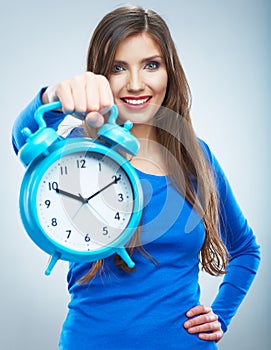 Young smiling woman in blue hold watch. Beautiful smiling girl