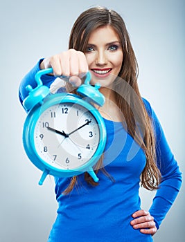 Young smiling woman in blue hold watch. Beautiful smiling girl