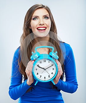 Young smiling woman in blue hold watch. Beautiful smiling girl