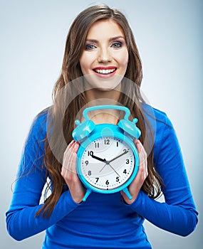 Young smiling woman in blue hold watch. Beautiful smiling girl