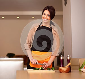 Young smiling woman cooking healthy salad