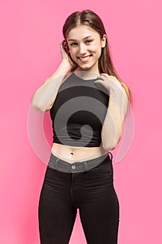 Young smiling woman corrects her hair