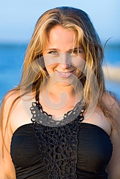 Young smiling woman with dishevelled hairs