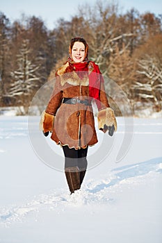 Young smiling woman dressed in sheepskin fur coat photo