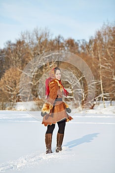 Young smiling woman dressed in sheepskin fur coat photo