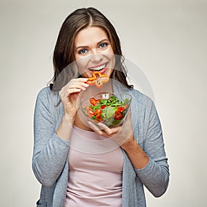 Young smiling woman eating salad. photo