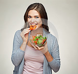 Young smiling woman eating salad. photo