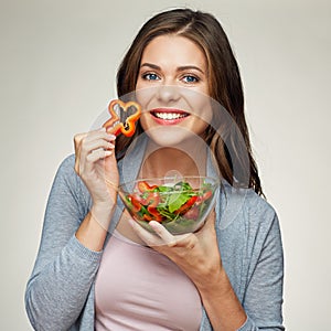 Young smiling woman eating salad photo