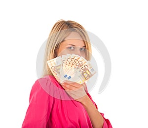 Young smiling woman holding fan made of Euro money