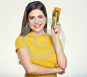 Young smiling woman holding glass with carrot.