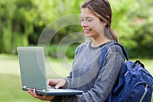 Young smiling woman holding her laptop