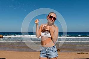 Young smiling woman holding ice cream