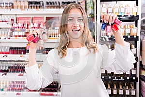 Woman holding nail polish bottles