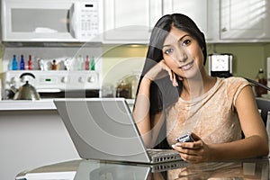 Young Smiling Woman With Laptop and Cellphone