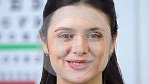 Young smiling woman on ophthalmology examination, health check in clinic