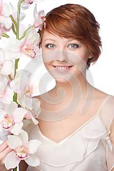 Young smiling woman with orchid