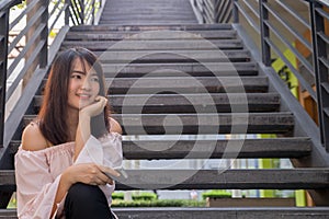 Young smiling woman outdoors portrait. Soft sunny colors.Close portrait. beautiful smiling girl. Woman in the city in summertime.