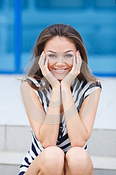 Young smiling woman outdoors portrait.