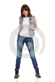 Young Smiling Woman Is Posing In Unbuttoned Jeans Vest