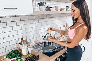 Young smiling woman preparing healthy breakfast. Diet, fitness and wellbeing.