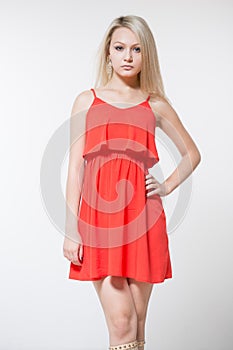Young smiling woman in red dress. Isolated over white background.