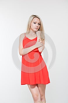 Young smiling woman in red dress. Isolated over white background.