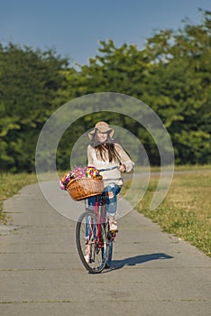 Young smiling woman rides a bicycle