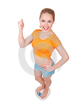 Young smiling woman on scales