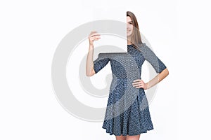 Young smiling woman show blank card or paper