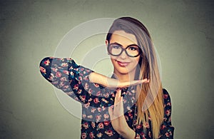 Young smiling woman showing time out