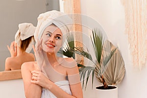 Young smiling woman smiling after spa treatments in bathroom